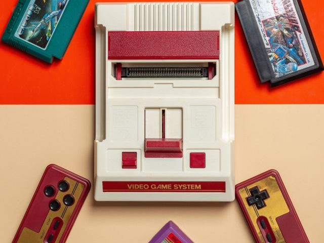 Picture of a Famicom console with controllers and games