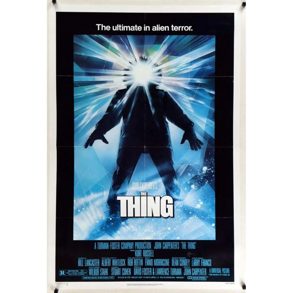 The Thing film poster shows a parka-clad figure with brilliant light emerging from its hood.