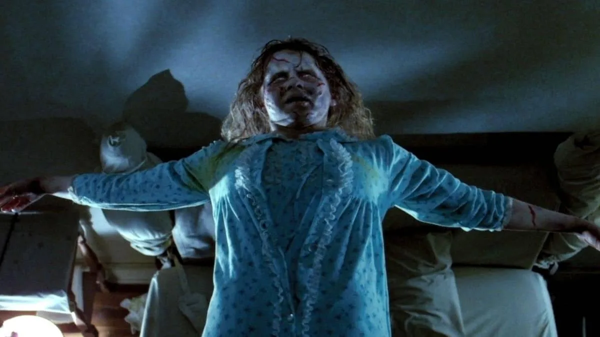 Historical film imagery shows Regan on a bed in The Exorcist.